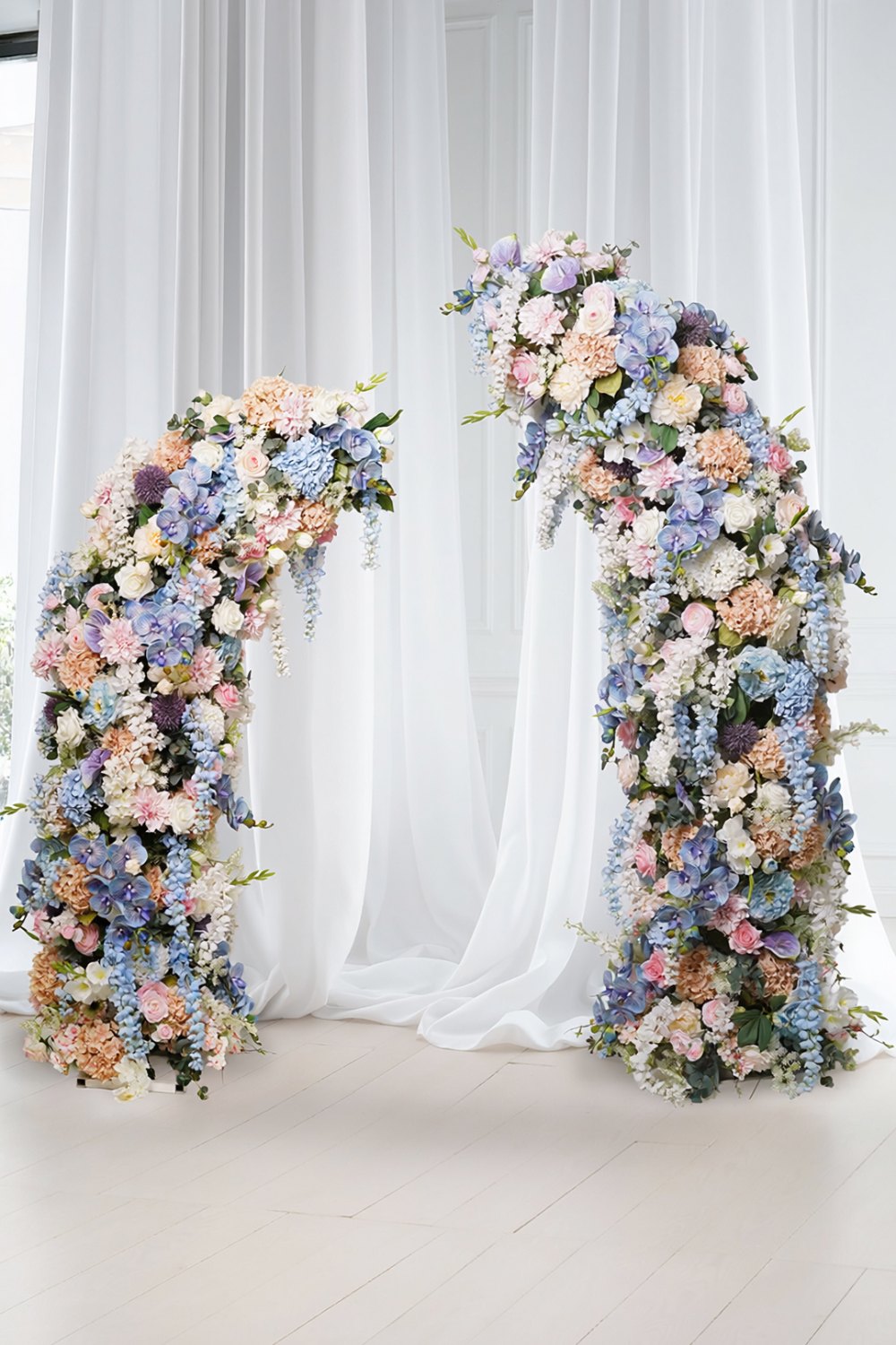Artificial floral arch wedding backdrop Singapore Blush and blue artificial floral arch with sheer drapery as a wedding ceremony backdrop in Singapore